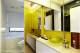 
                                    卫浴室使用立面茶镜将视觉效果延伸加大，让小平数在镜面的层层照映中放大空间的宽敞感，并成功运用黄色油漆刷出活泼的空间表情。
